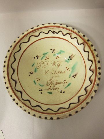 Dish, pottery, from the well known dänish potter, Winther (1838-1919), from 
Sønderborg in Jylland
Inscription: P. J. Wolf Lillekobbel pa Als Kegenis 1869