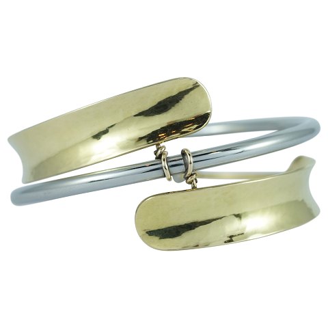 Ole Bent Petersen; A Danish designed bangle of 18k gold and steel