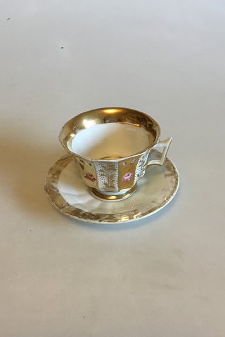 Faceted coffee cup decorated with roses and gold. Probably German