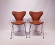 A pair of Seven chairs, model 3107, in cognac colored savanne leather, designed 
by Arne Jacobsen and Fritz Hansen.
5000m2 showroom.
