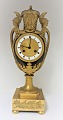 Lundin Antique 
presents: 
Very well 
kept French 
Empire vase 
shaped mantle 
clock of gilt 
and patinated 
bronze. ...