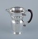 L'Art presents: 
Georg 
Jensen, large 
Art Nouveau 
pitcher in 
sterling 
silver. Early 
and rare model. 
Hammered ...