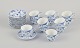 L'Art presents: 
Royal 
Copenhagen Blue 
Fluted Half 
Lace, a set of 
twelve pairs of 
demitasse cups.