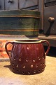 K&Co. presents: 
Old 1800s 
glazed ceramic 
jar with holes 
and handle...