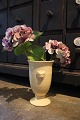 K&Co. presents: 
Old 
cream-coloured 
glazed ceramic 
vase with 
lion's head...
