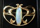 Lundin Antique 
presents: 
Gold 
brooch with 
opal (585. 
Length 4 cm