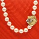 Antik 
Damgaard-
Lauritsen 
presents: 
Ole 
Lynggaard; A 
pearl necklace 
with clasp of 
14k gold with a 
diamond