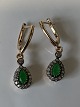 Antik Huset 
presents: 
Earrings 
in 14 carat 
gold with 
beautiful green 
emeralds and 
white stones.