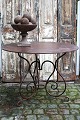 K&Co. presents: 
Old French 
round cafe iron 
table in 
polished 
wrought iron...