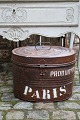 K&Co. presents: 
Old oval 
metal box with 
old original 
paint, fine 
patina and 
writing on the 
side "Paris"...