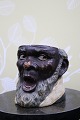 K&Co. presents: 
Antique, 
19th century 
terracotta jar 
with the face 
of an African 
man with a nice 
old patina...