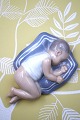 K&Co. presents: 
Royal 
Copenhagen, 
porcelain 
figurine of a 
small child 
sleeping on a 
pillow...