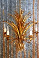 K&Co. presents: 
chandelier 
designed by 
Hans Kögl from 
the 60s, shaped 
like a 
cornflower in 
gilded metal...