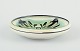 L'Art presents: 
Kähler, 
Denmark.
Ceramic bowl 
with floral 
motif. Glaze in 
green and black 
tones.