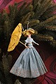 K&Co. presents: 
Old 
Christmas tree 
ornament, nice 
lady with 
umbrella made 
of colored 
crepe paper...