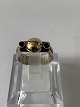 Antik Huset 
presents: 
Silver 
ring with 18 
carat gold and 
2 green stones.
Size: 54