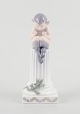 L'Art presents: 
Royal 
Copenhagen, 
porcelain 
figurine.
Whistling Pan 
sitting on a 
pedestal with a 
salamander.