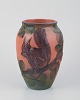 L'Art presents: 
Ipsens, 
Denmark, 
ceramic vase 
with squirrel, 
glaze in orange 
and green 
tones.