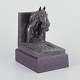 L'Art presents: 
Jeanne 
Patricia 
Rynhart 
(1946–2020), 
Irish sculptor.
Bronze bookend 
on wooden base.