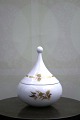 K&Co. presents: 
Small 
Rosenthal Bjorn 
Wiinblad lidded 
jar in white 
porcelain with 
gold 
decorations...