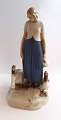 Lundin Antique 
presents: 
Bing & 
Gröndahl. 
Porcelain 
figurine. Goose 
girl. Model 
2254. Height 
24.5 cm. (2 
quality).