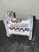 Reutemann Antik 
presents: 
Faiance 
digure: Cradle 
With Child as 
Money box From 
Aluminia / 
Royal 
Copenhagen