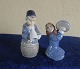Antikkram 
presents: 
Royal 
Copenhagen 
Denmark, pair 
of figurines 
Nos 3677 Girl 
with pot lid 
and No 3689, 
Boy ...