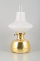 L'Art presents: 
Henning 
Koppel for 
Louis Poulsen.
Petronella oil 
lamp in brass 
with an opal 
glass shade.