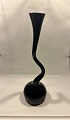 Stentoft Antik 
presents: 
Black 
swing vase from 
Normann 
Copenhagen 29. 
8 cm Glass vase 
with a curved 
Asymmetrical
