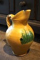 K&Co. presents: 
Old 
Italian ceramic 
wine jug with 
fine yellow 
glaze and 
twisted 
handle...