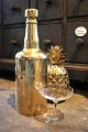 K&Co. presents: 
Old 
champagne 
cooler in the 
shape of a 
large bottle in 
brass that can 
be opened and 
filled with ...