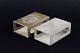 L'Art presents: 
Just 
Andersen. Two 
pewter matchbox 
holders, model 
260 and 78. 
Denmark, c. 
1930.