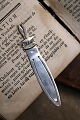 K&Co. presents: 
Old 
bookmark in 
silver 
(stamped) 
Length 8.5cm. 
with bird motif 
and text 
"Texel"...