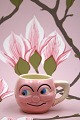 K&Co. presents: 
Old 
children's cup 
with a funny 
face in 
faience...