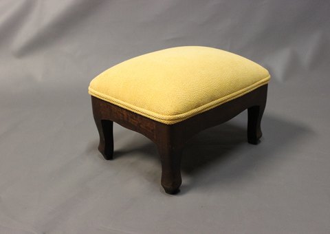 Small footstool in polished mahogany and bright yellow fabric.
5000m2 showroom.