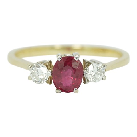 A ruby ring set with diamonds mounted in 18k gold