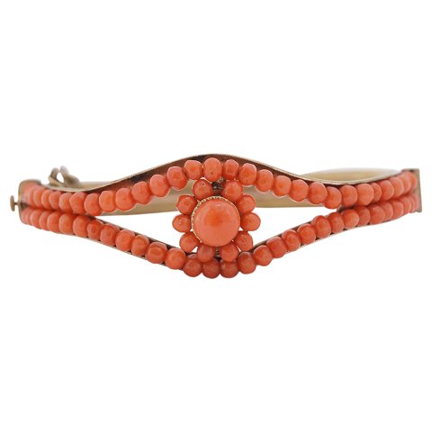 A gilted bangle set with corals