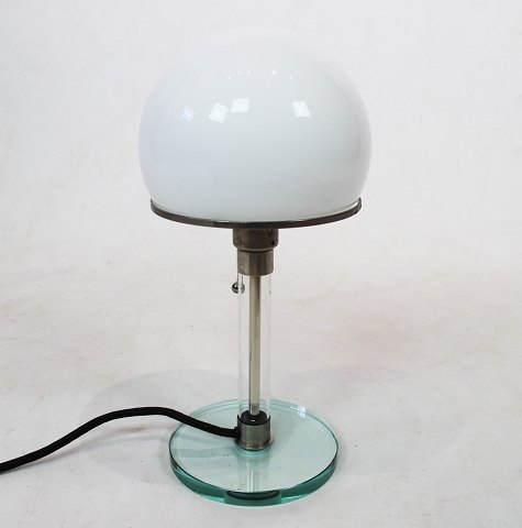 Table lamp by Wilhelm Wagenfeld designed in 1923-24 and is with shade of white 
opaline glass, frame of steel, stem and foot of glass.
5000m2 showroom.