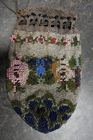 Antique Handmade bag, made of beads
This beautiful old handmade bag, from about the end of the 1800-years, is 
handmade of beads with embroidery which shows flowers/roses
The shape is with cords at the top that can tie the bag together