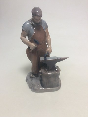 Royal Copenhagen figurine of a blacksmith no 460. Old Bing and Grondahl number 
is 2225