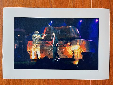 Vintage press photo of Michael Jackson standing in front of tank on caterpillar 
feet during HIStory World Tour in Moscow, Russia, 1996.