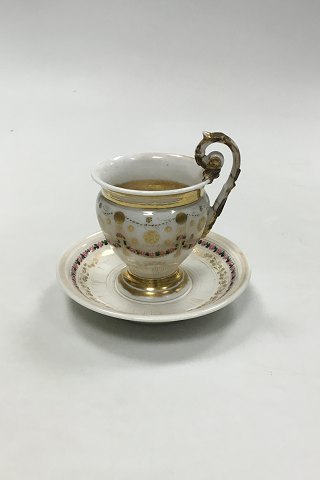 Old Cup and Saucer Decorated with Flowers and gold
