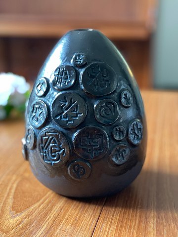 Ceramic vase by Hans Helving, Bornholm, in 1965. Brown glazed with "amulets" 
with symbols in relief