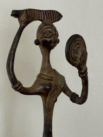 Large bronze figure of woman combing her hair and looking in the mirror. Asia