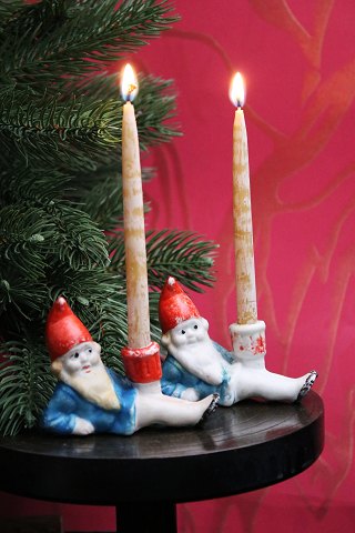 Old Christmas candlestick in  bisque of Santa Claus lying down holding a small 
Christmas candle...