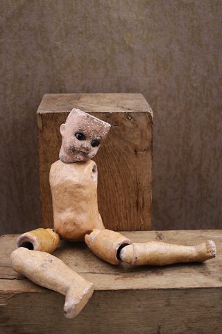 Old 19th century doll, head with glass eyes, body and legs in painted 
papier-mâché ...