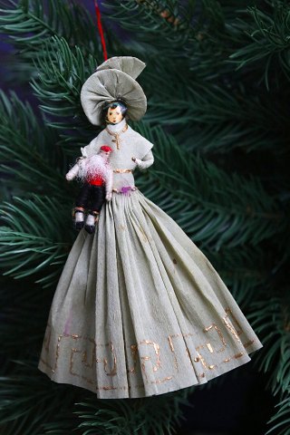 Old Christmas tree ornament, nice lady holding a small Santa Claus doll, made of 
colored crepe paper...