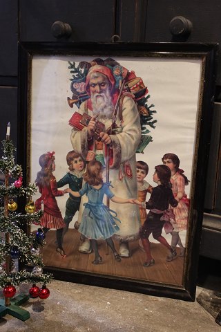 Old picture with motif of Santa Claus handing out gifts to children...
