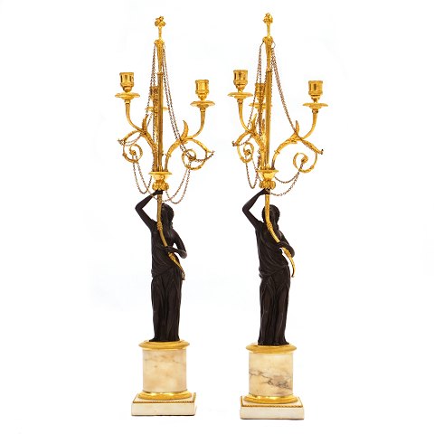 Pair of French firegilt bronze candelabra with 
marble base. France circa 1810. H: 73cm