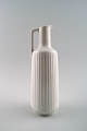 German jug in white porcelain, modern design, fluted.
